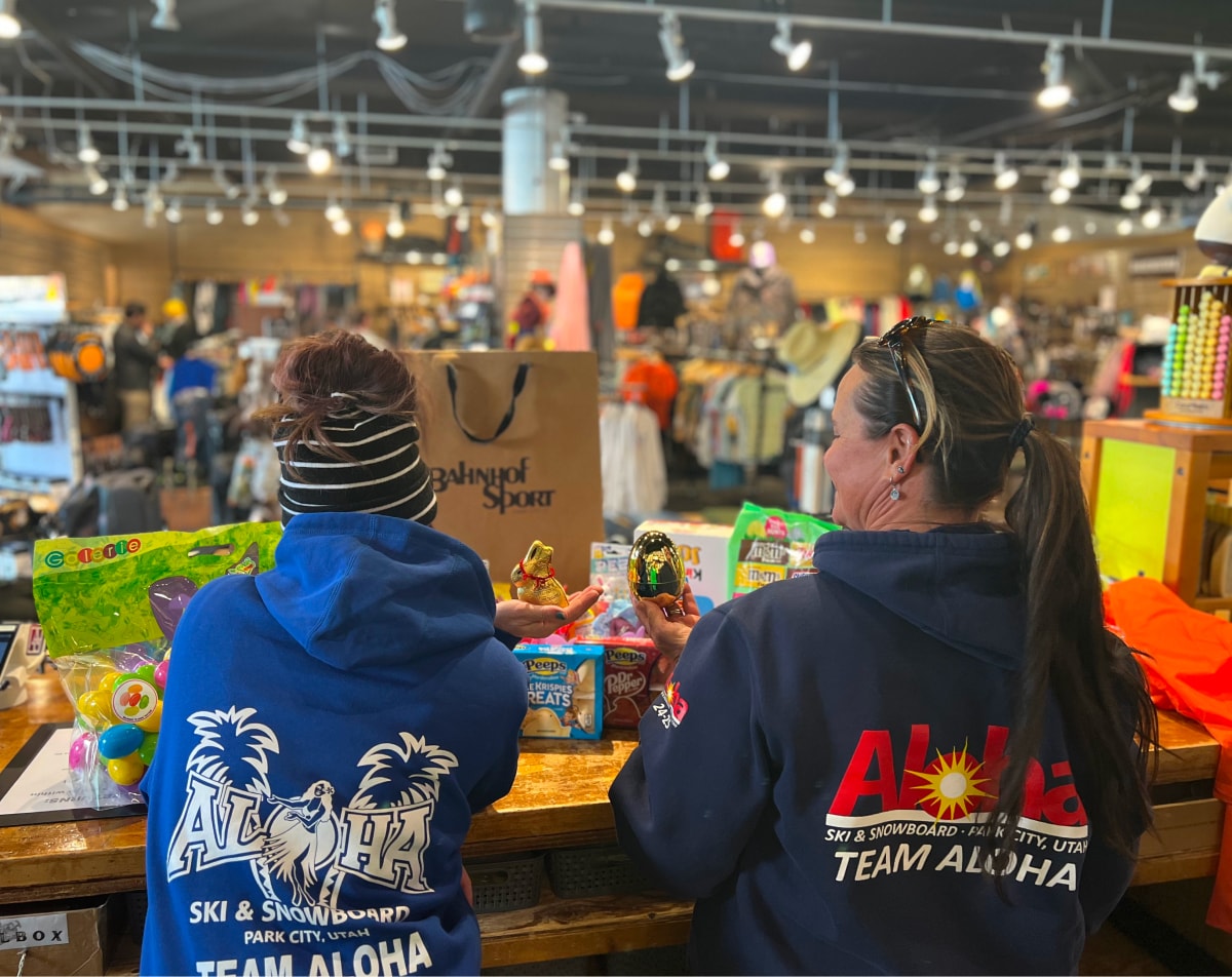 Two Aloha Ski & Snowboard Rental team members inside shop