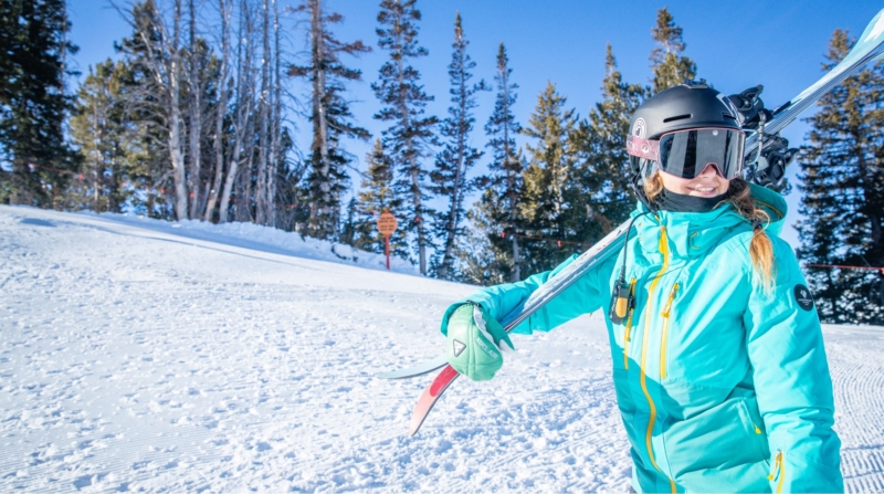 Smiling skier at the base of a mountain in Park City, UT